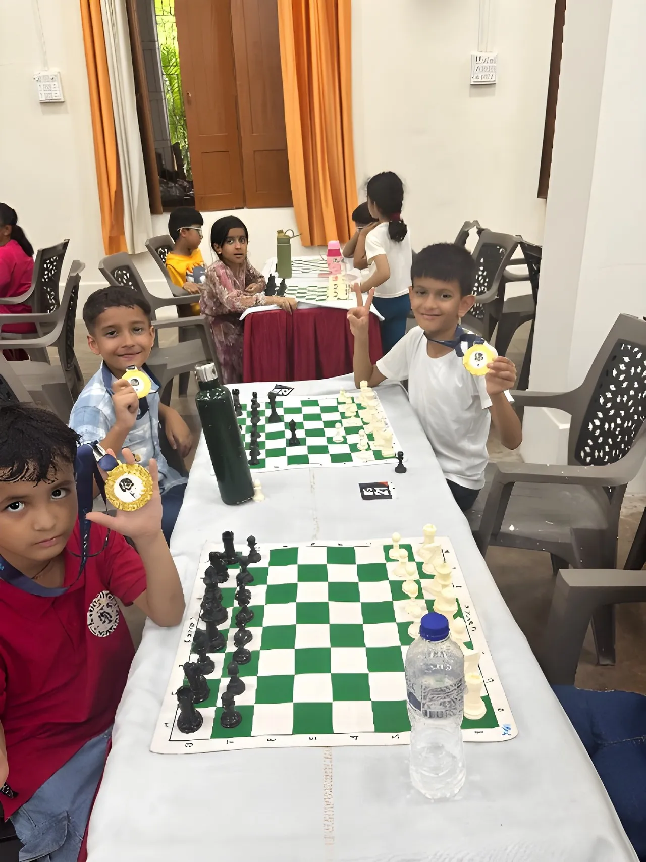 Young players at the boards with their medals at the Prime Engage Jr. Chess Championship
