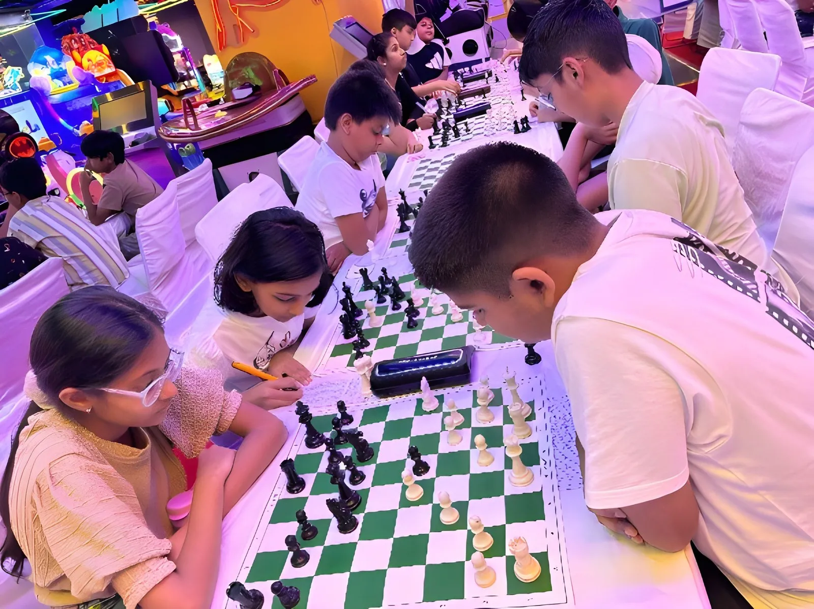 Children mid-game at their boards in the Masti Zone play area, Delhi, under arcade lights