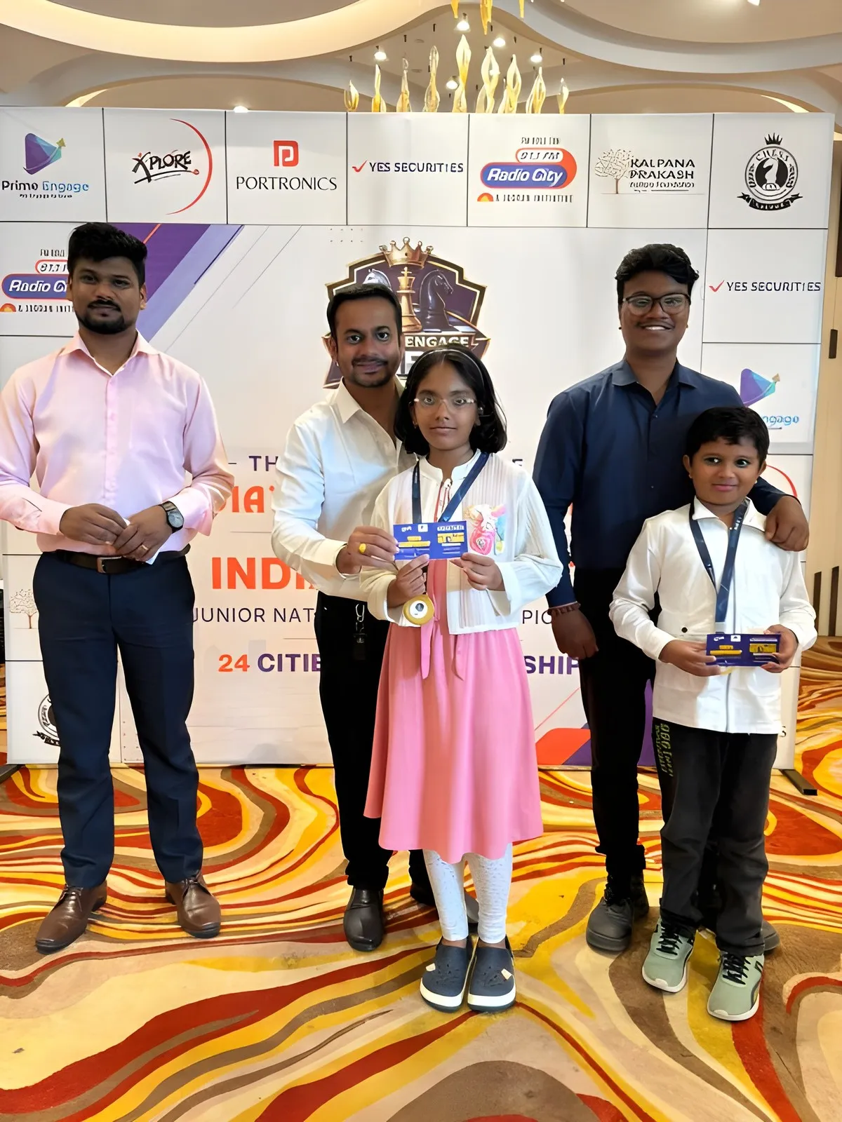 Prize presentation at the championship backdrop with partner logos, Nagpur round