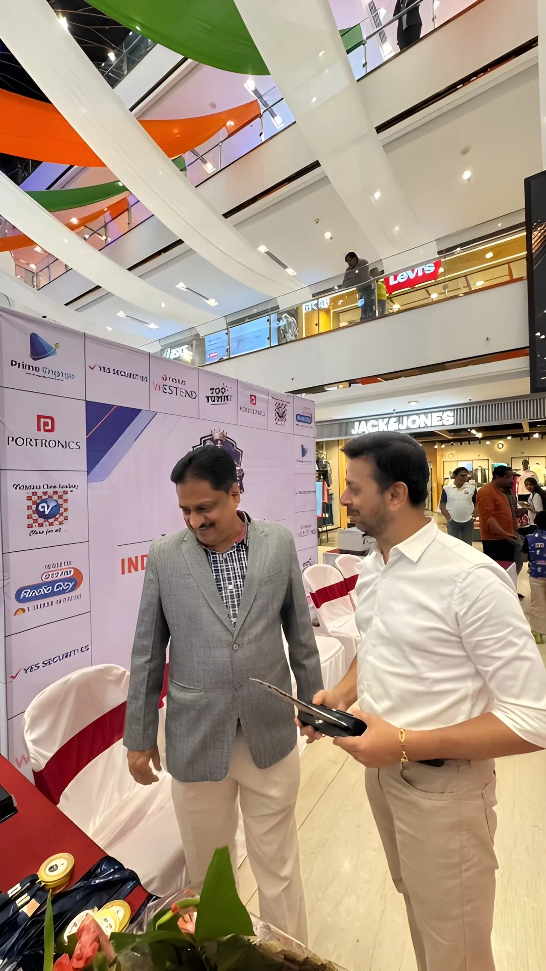 Mr. Rajendra Konde and Mr. Jayant Gokhale at the championship backdrop.
