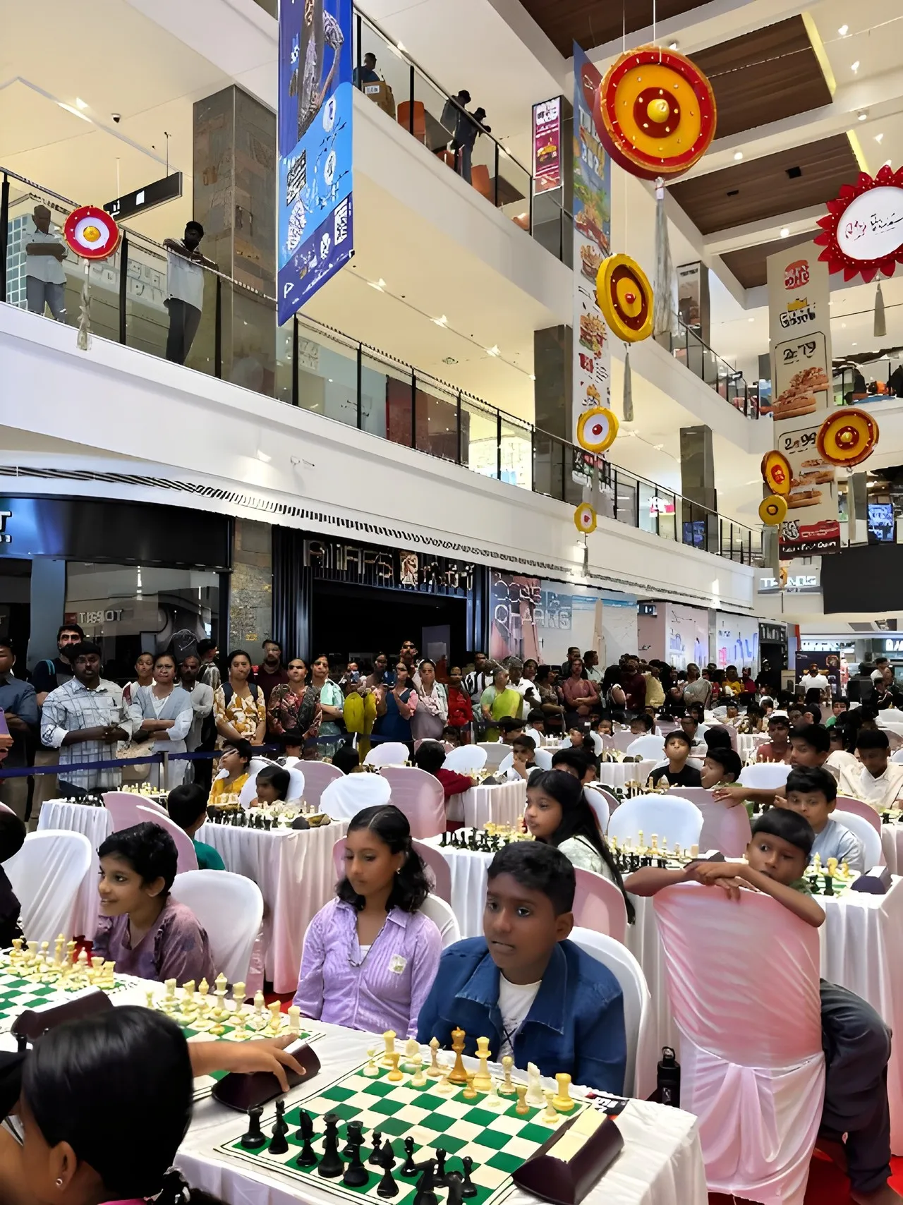 The hall at Mall of Travancore during play, with the balconies full of families at the Prime Engage Jr. Chess Championship